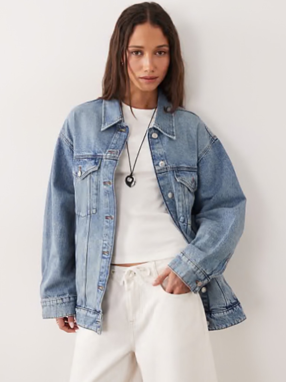 Zara oversized light-wash denim jacket featuring fading and distressed details.